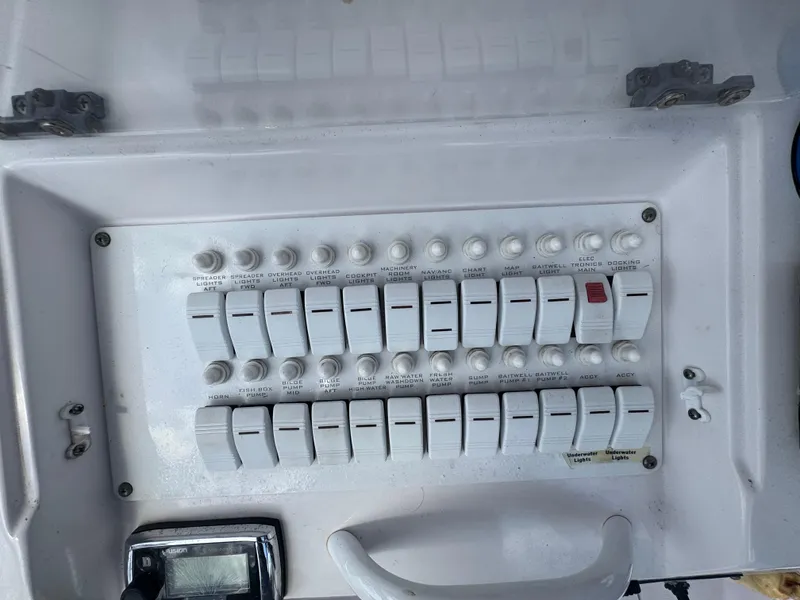 Slide: The Image of Control panel of a 2006 Donzi 38 ZSF boat with multiple switches and dials. - 22