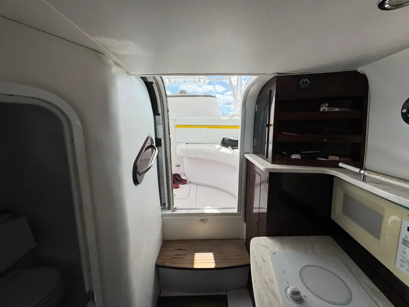 Slide: The Image of Interior view of a 2006 Donzi 38 ZSF boat, featuring compact cabin amenities. - 24