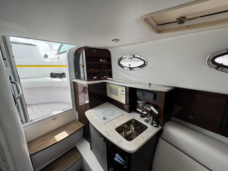 Slide: The Image of Interior of 2006 Donzi 38 ZSF boat with kitchenette, sink, and microwave. - 26