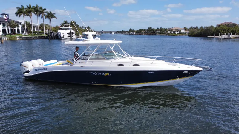 Slide: The Image of 2006 Donzi 38 ZSF boat cruising on a sunny day in a scenic waterway. - 3