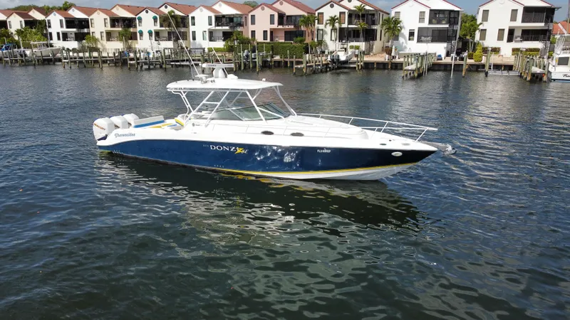 Slide: The Image of 2006 Donzi 38 ZSF boat on water near waterfront homes. - 4