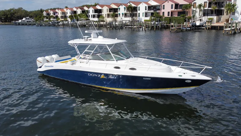 Slide: The Image of 2006 Donzi 38 ZSF boat on water near colorful waterfront homes. - 7