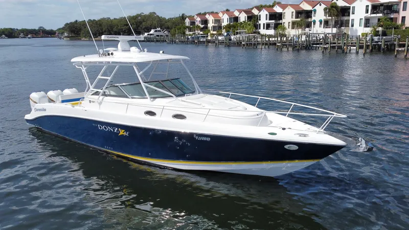 Slide: The Image of 2006 Donzi 38 ZSF boat on water near waterfront homes. - 8