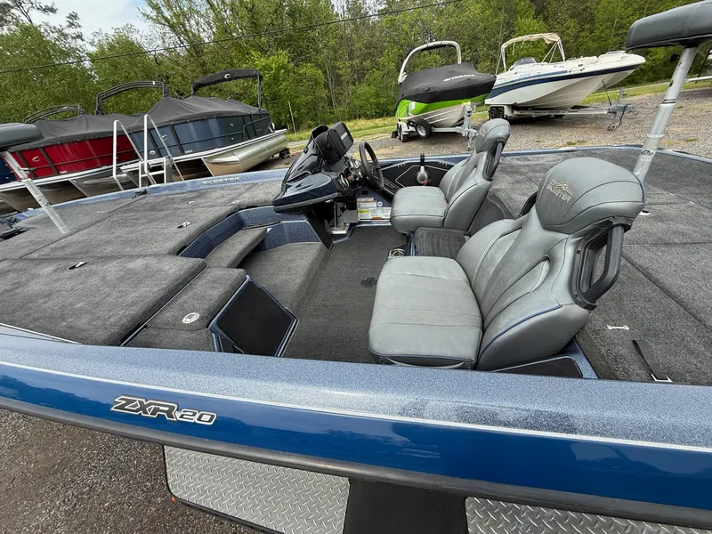 Slide: The Image of 2023 Skeeter ZXR20 boat with gray seats, parked among other boats. - 12