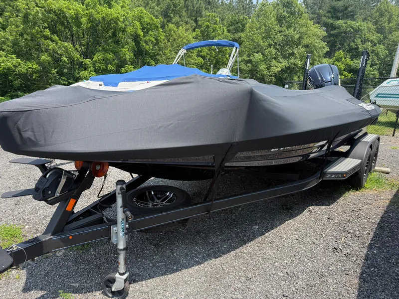 Slide: The Image of 2023 Skeeter ZXR20 boat with cover on trailer, parked outdoors. - 14
