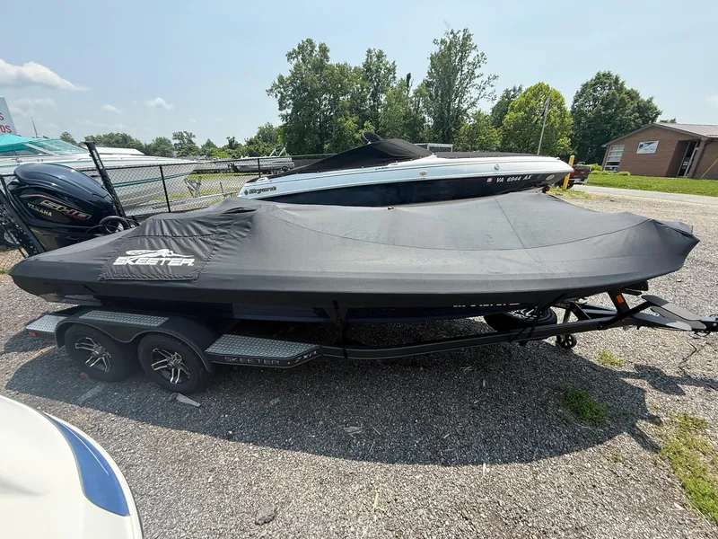 Slide: The Image of 2023 Skeeter ZXR20 boat covered on a trailer, parked outdoors. - 15