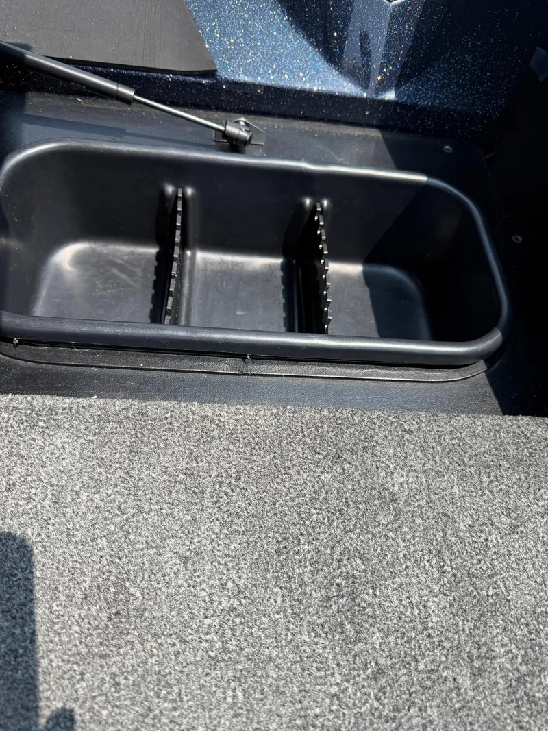 Slide: The Image of 2023 Skeeter ZXR20 boat storage compartment with carpeted flooring. - 17