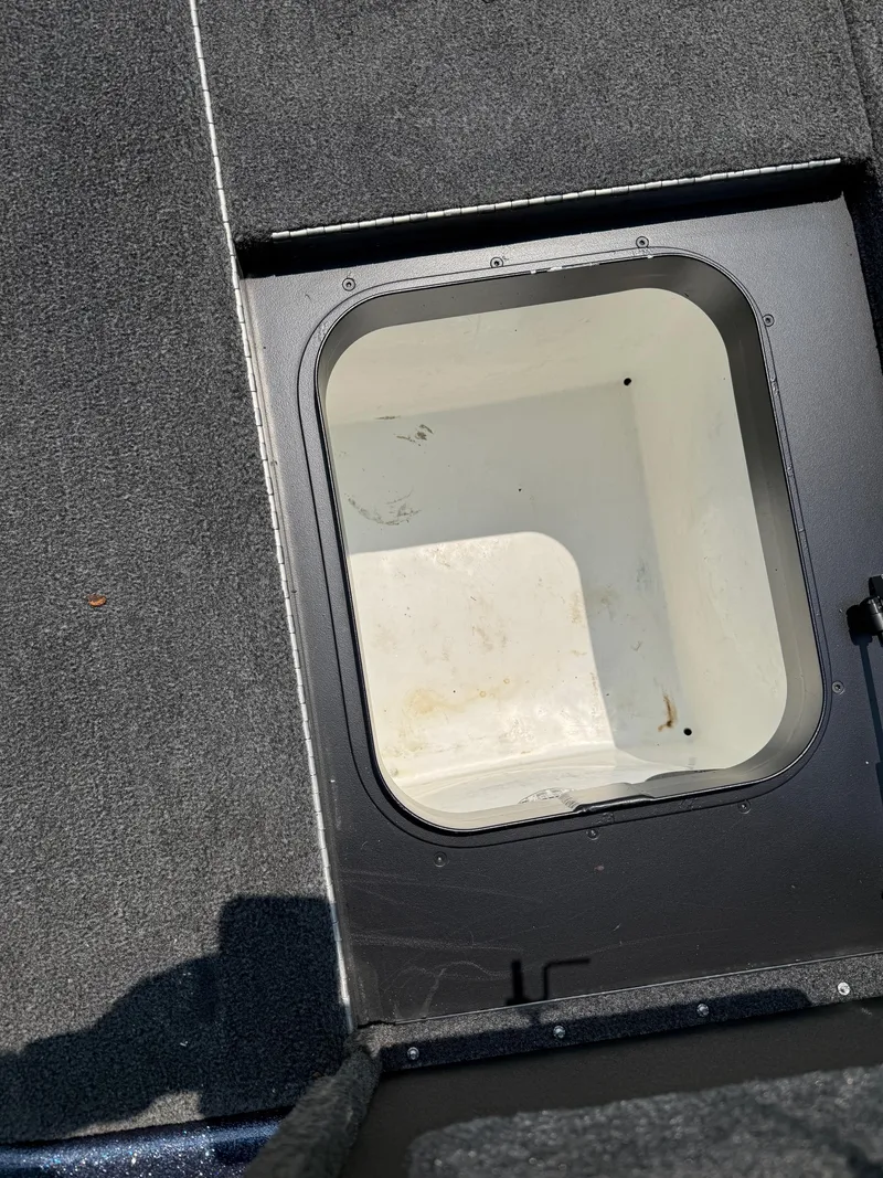 Slide: The Image of 2023 Skeeter ZXR20 boat storage compartment with open hatch, showing interior space. - 18