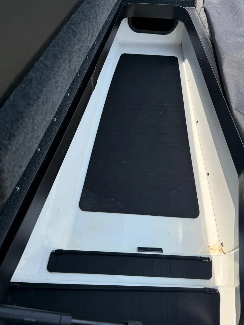 Slide: The Image of 2023 Skeeter ZXR20 boat interior storage compartment, featuring a sleek black and white design. - 19