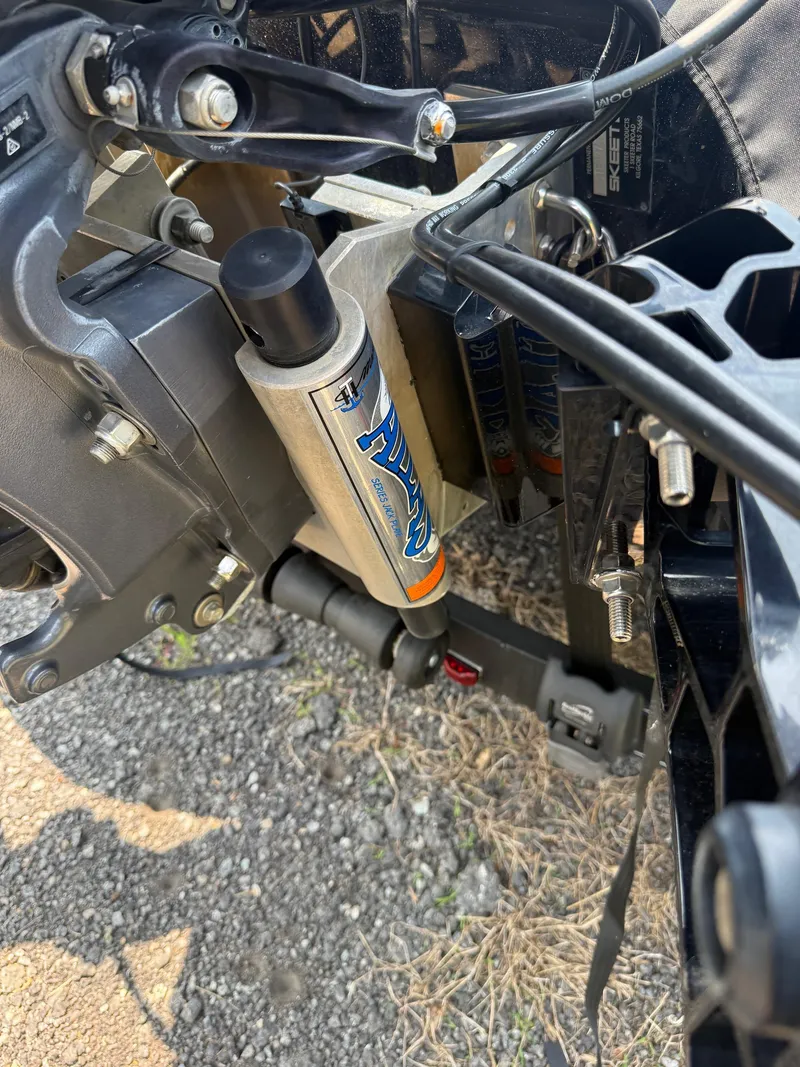 Slide: The Image of Close-up of 2023 Skeeter ZXR20 boat engine components on gravel surface. - 22