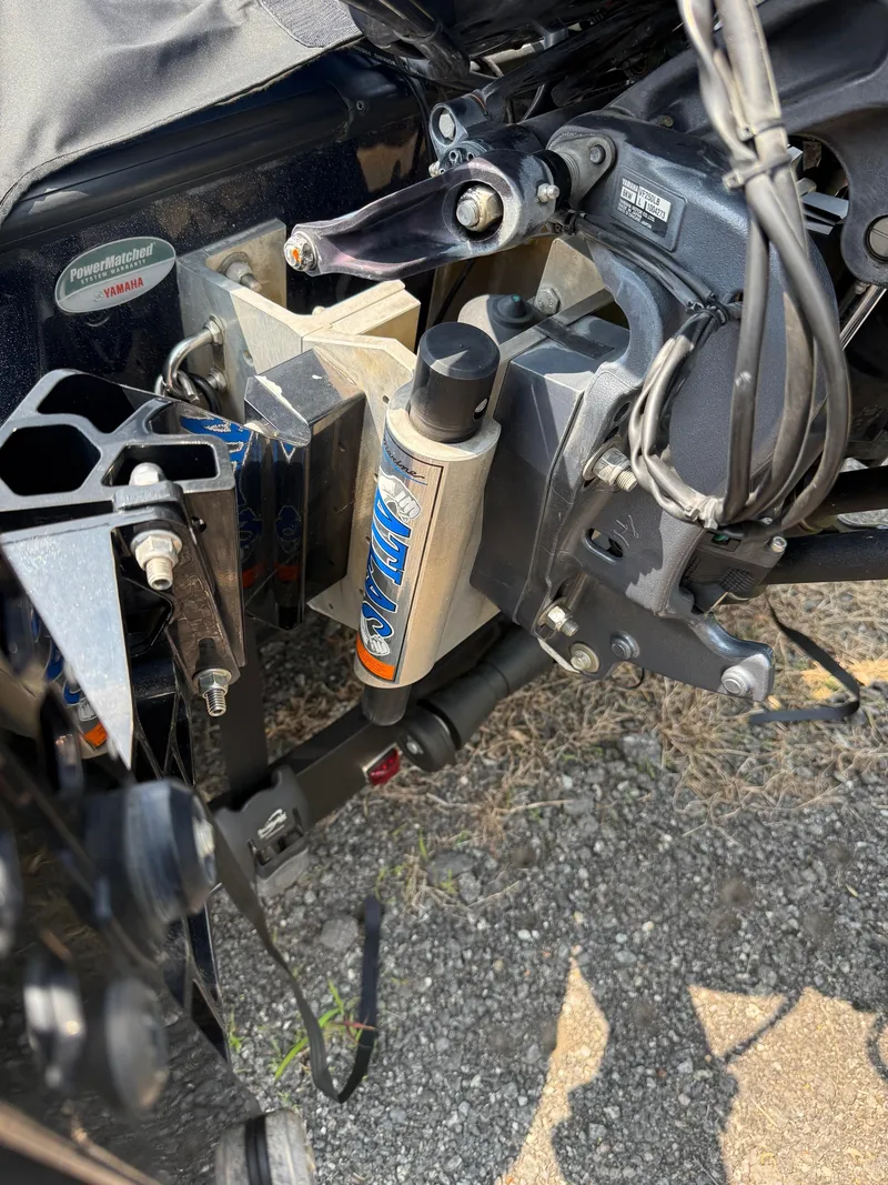 Slide: The Image of 2023 Skeeter ZXR20 boat engine components on gravel surface. - 23