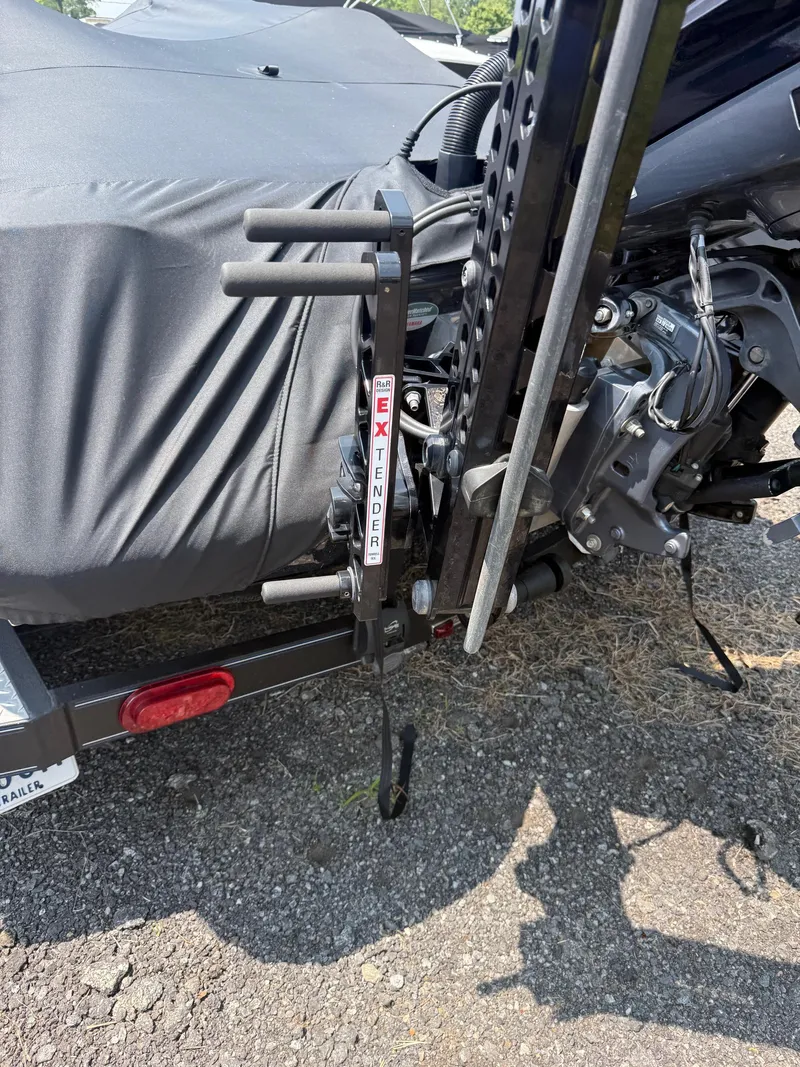 Slide: The Image of 2023 Skeeter ZXR20 boat trailer with extender accessory on asphalt surface. - 26