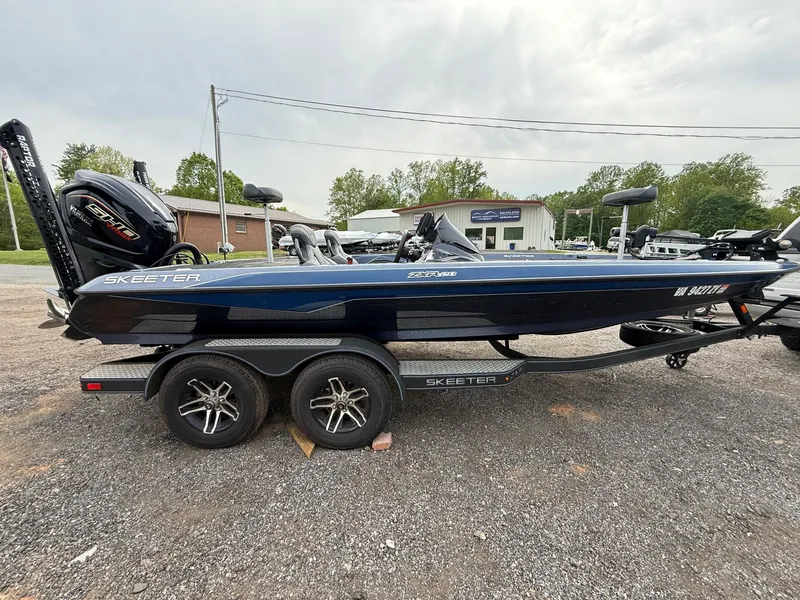 Slide: The Image of 2023 Skeeter ZXR20 boat on trailer, parked outdoors, side view. - 9
