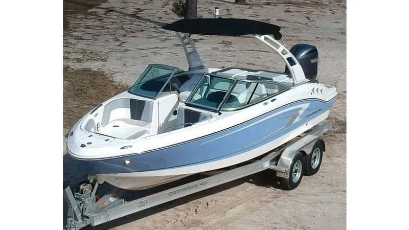 Slide: The Image of 2024 Chaparral 21 SSi OB boat on trailer, featuring sleek design and blue accents. - 2