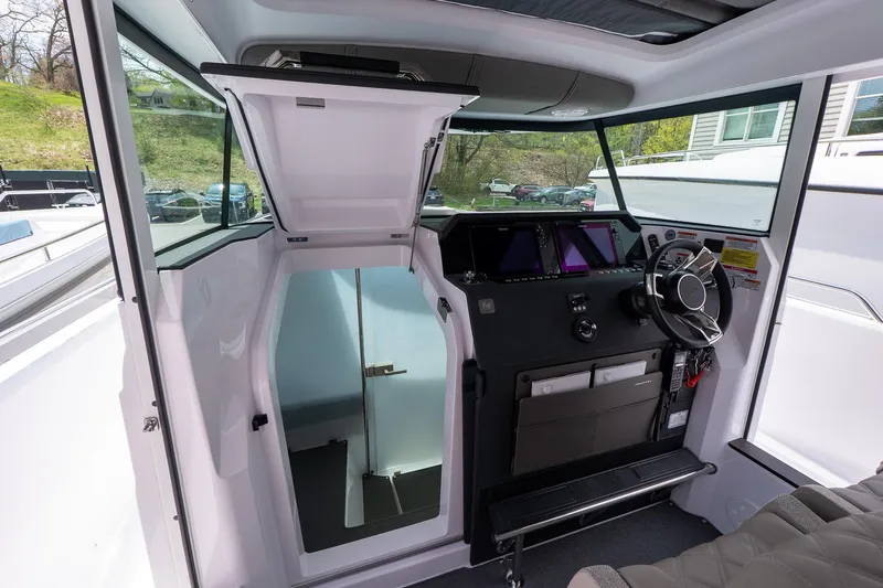 Slide: The Image of 2024 Axopar Cross Cabin interior with modern helm and sleek design. - 39