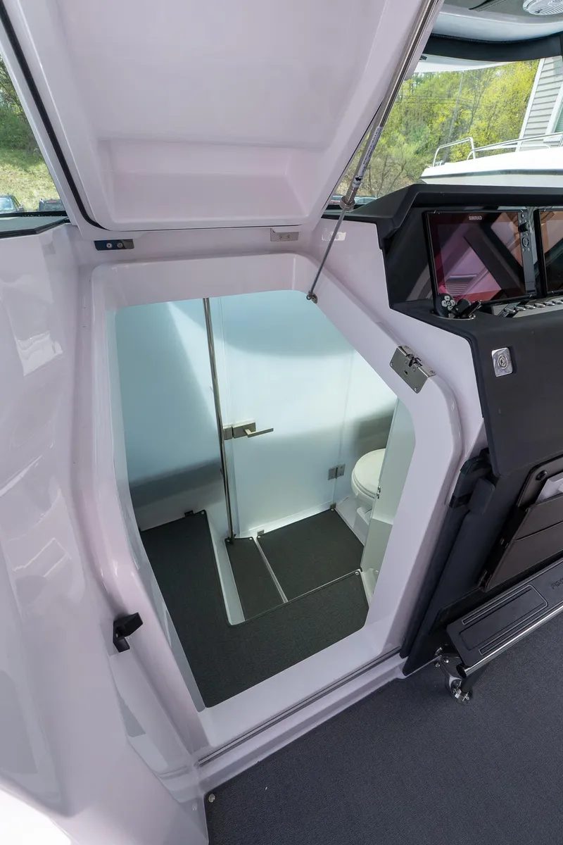 Slide: The Image of 2024 Axopar Cross Cabin interior with compact bathroom and modern design. - 40