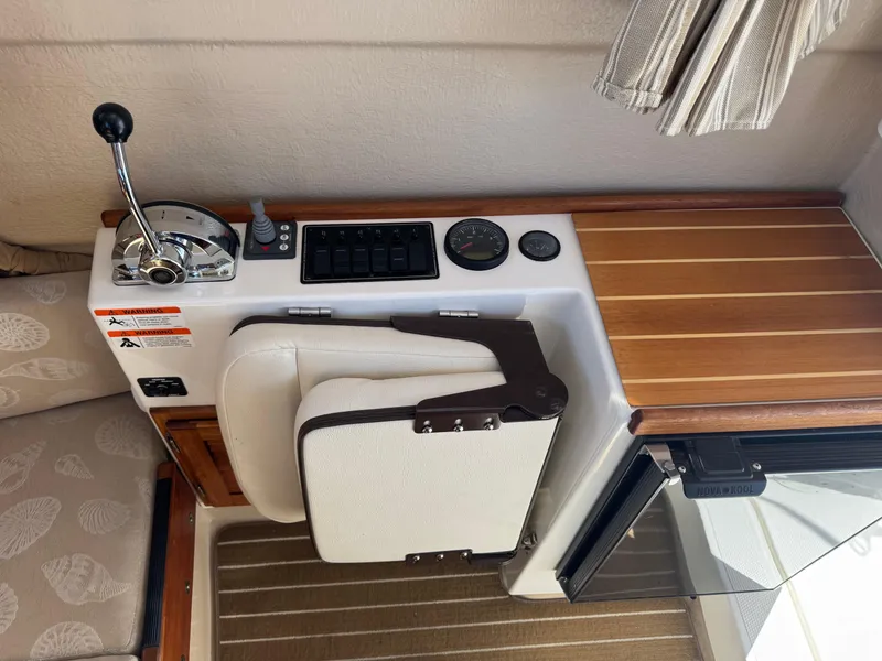 Slide: The Image of Interior view of a 2016 Ranger Tugs R-21EC boat dashboard with controls and seating. - 13