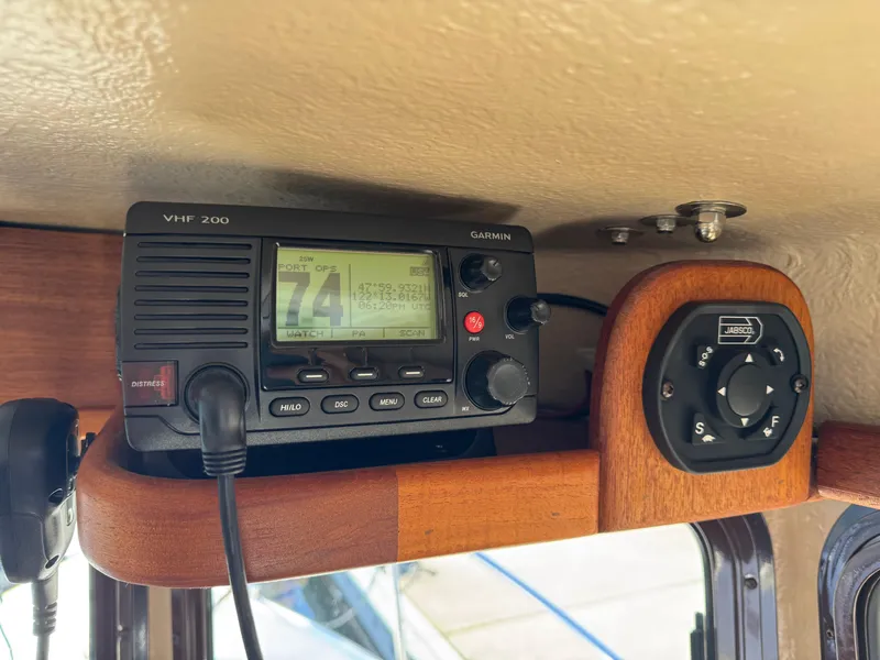 Slide: The Image of VHF radio and control panel inside 2016 Ranger Tugs R-21EC boat. - 15