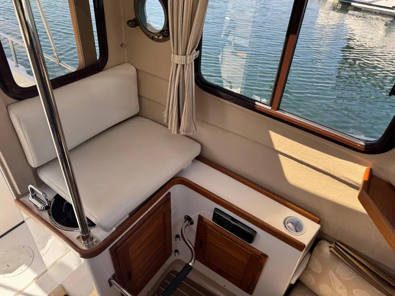 Slide: The Image of Interior of 2016 Ranger Tugs R-21EC boat with seating and window view. - 17