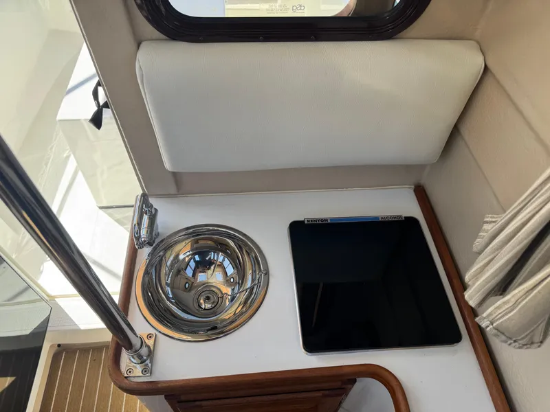 Slide: The Image of 2016 Ranger Tugs R-21EC interior with sink and stove, compact and efficient design. - 18