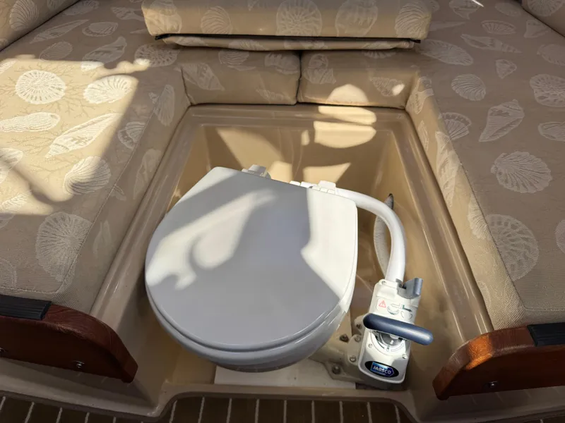 Slide: The Image of 2016 Ranger Tugs R-21EC boat interior with a compact marine toilet. - 23