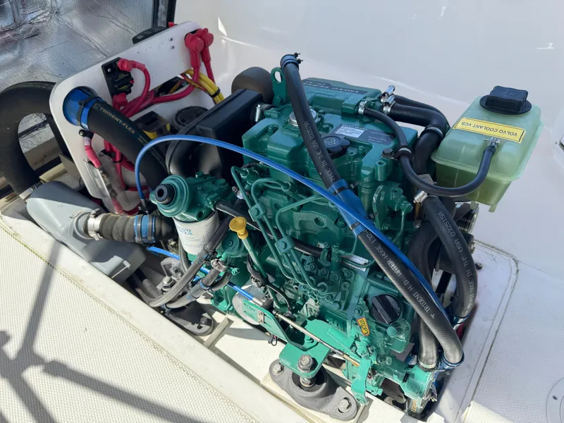 Slide: The Image of Engine compartment of a 2016 Ranger Tugs R-21EC, showcasing detailed mechanical components. - 25