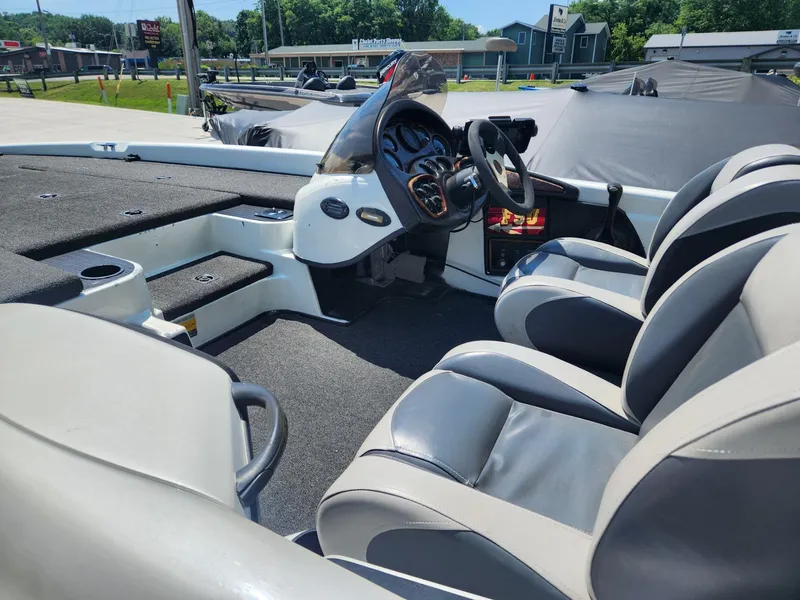 Slide: The Image of 2001 Triton TR21 boat interior with steering wheel and seating. - 11