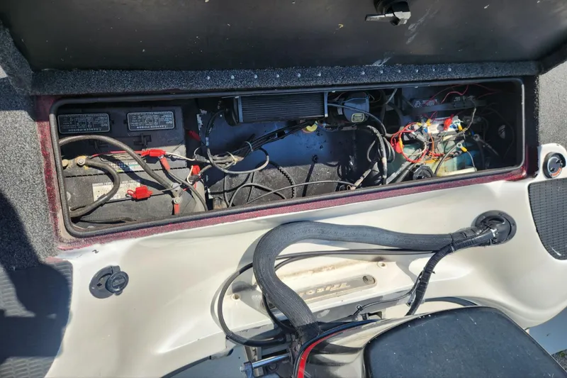 Slide: The Image of 2001 Triton TR21 boat battery compartment with wiring and components visible. - 14