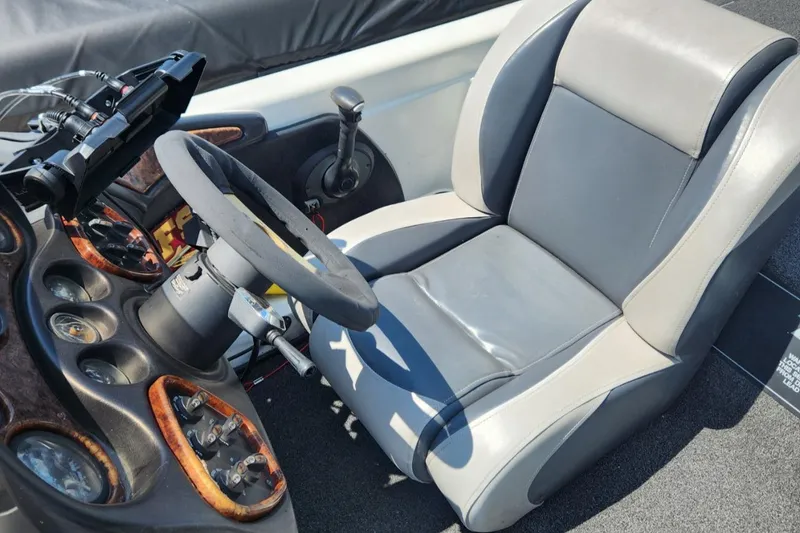 Slide: The Image of 2001 Triton TR21 boat cockpit with steering wheel and control panel. - 15