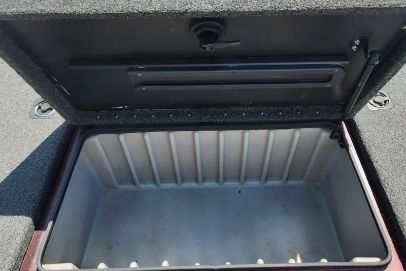 Slide: The Image of Open storage compartment in a 2001 Triton TR21 boat, showing interior space. - 16