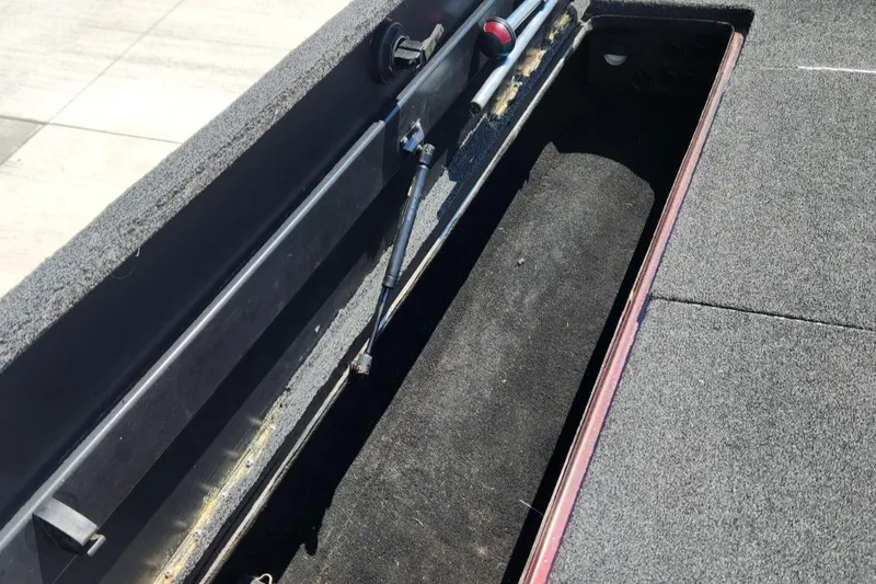 Slide: The Image of Open storage compartment in a 2001 Triton TR21 boat, showing interior details. - 18