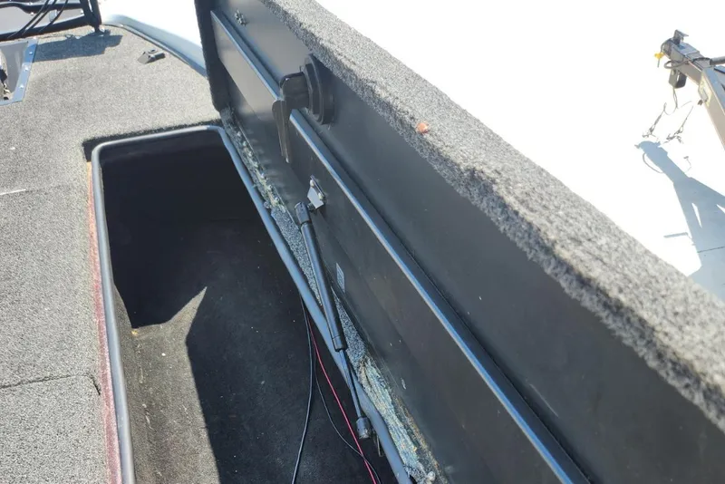 Slide: The Image of Open storage compartment on a 2001 Triton TR21 boat, showing interior details. - 19