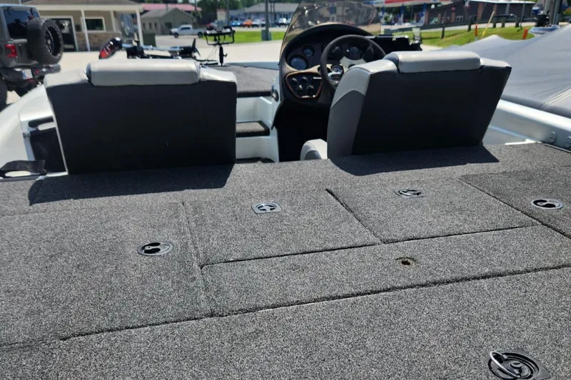 Slide: The Image of 2001 Triton TR21 boat interior with carpeted deck and dual seats. - 22