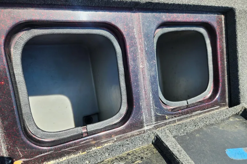 Slide: The Image of 2001 Triton TR21 boat storage compartments with foam lining, open and empty. - 23