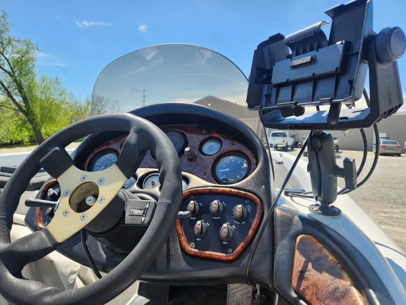 Slide: The Image of Dashboard of a 2000 Triton TR21 boat with steering wheel and mounted device holder. - 4