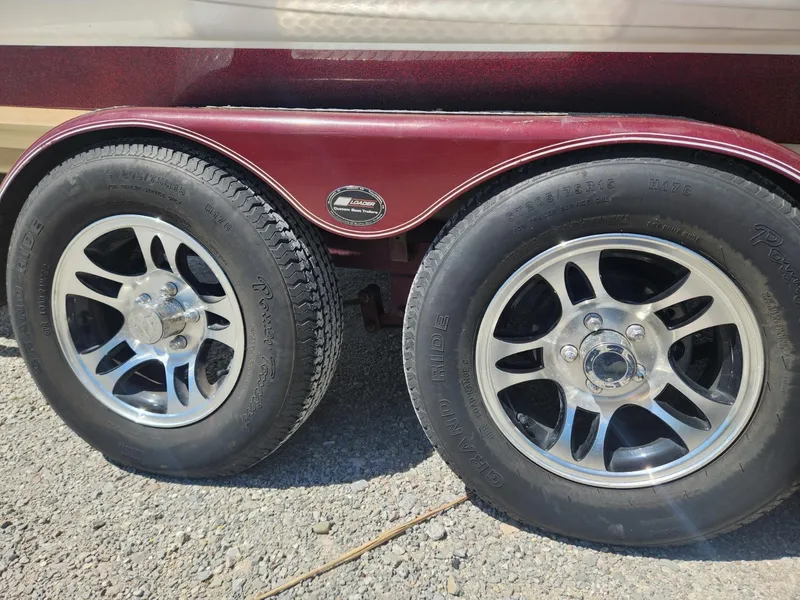 Slide: The Image of Dual wheels of a 2000 Triton TR21 trailer with shiny alloy rims. - 7