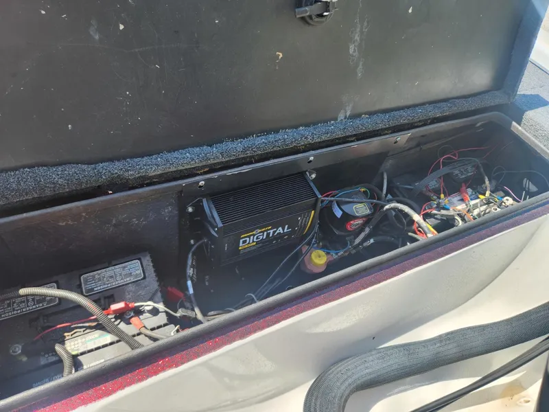 Slide: The Image of 2000 Triton TR21 boat battery compartment with digital charger and wiring. - 8