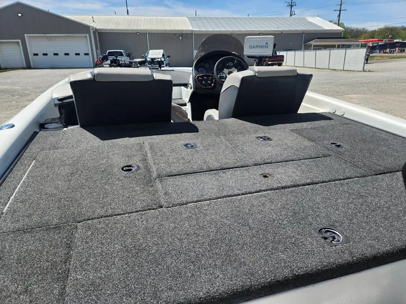 Slide: The Image of 2000 Triton TR21 boat interior with carpeted deck and dual seats. - 9