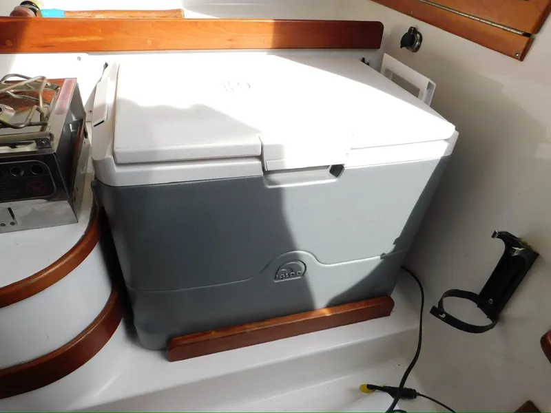 Slide: The Image of Cooler on 2014 Tartan Fantail boat interior, secured with wooden brackets. - 15