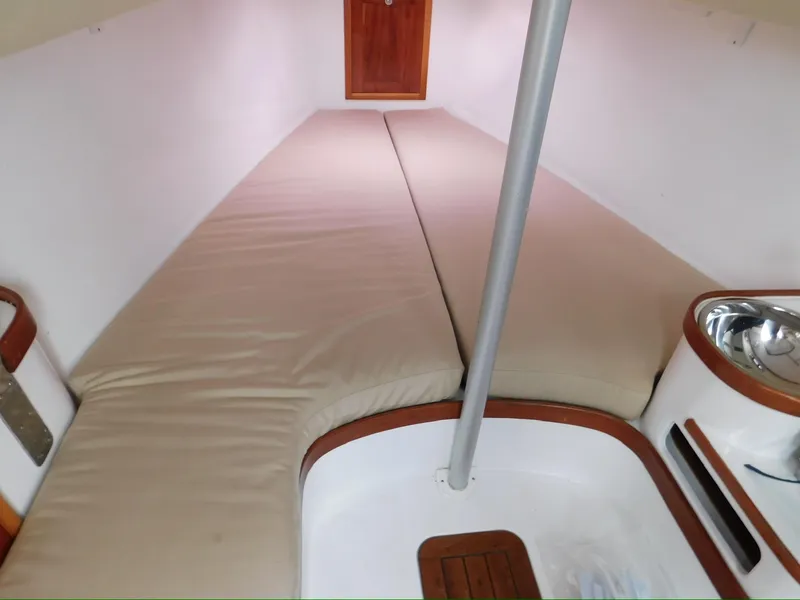 Slide: The Image of 2014 Tartan Fantail interior cabin with beige cushions and wooden accents. - 17