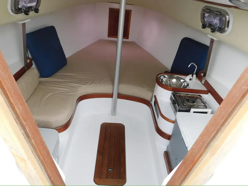Slide: The Image of Interior of a 2014 Tartan Fantail sailboat with cozy seating and compact kitchen area. - 18