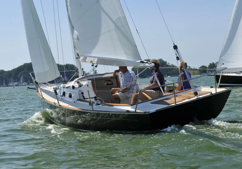 Slide: The Image of Sailing on a 2014 Tartan Fantail boat with three people on a sunny day. - 2
