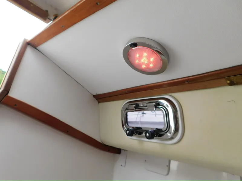 Slide: The Image of Interior of 2014 Tartan Fantail boat with red ceiling light and small window. - 23