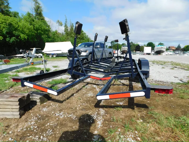 Slide: The Image of Boat trailer for Tartan Fantail 2014, parked outdoors on gravel, surrounded by greenery. - 24