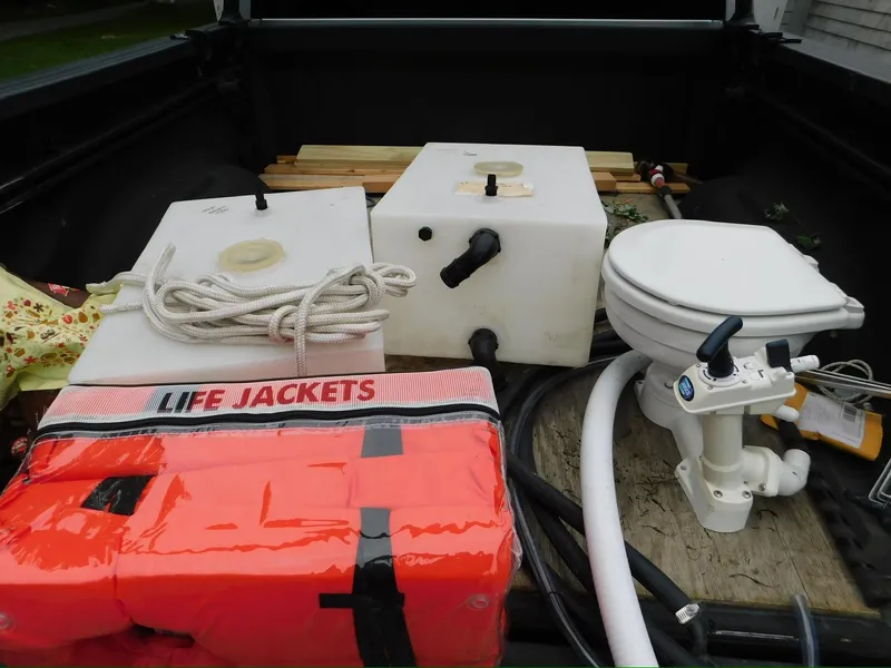 Slide: The Image of Boat equipment including life jackets, water tanks, and a marine toilet in a Tartan Fantail 2014. - 25