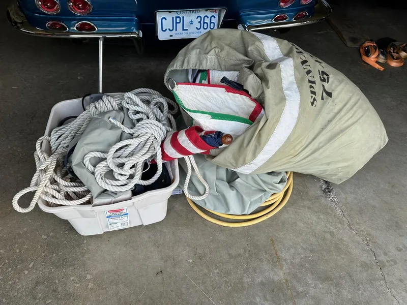 Slide: The Image of Sailing gear and ropes beside a Tartan Fantail 2014 in a garage. - 29
