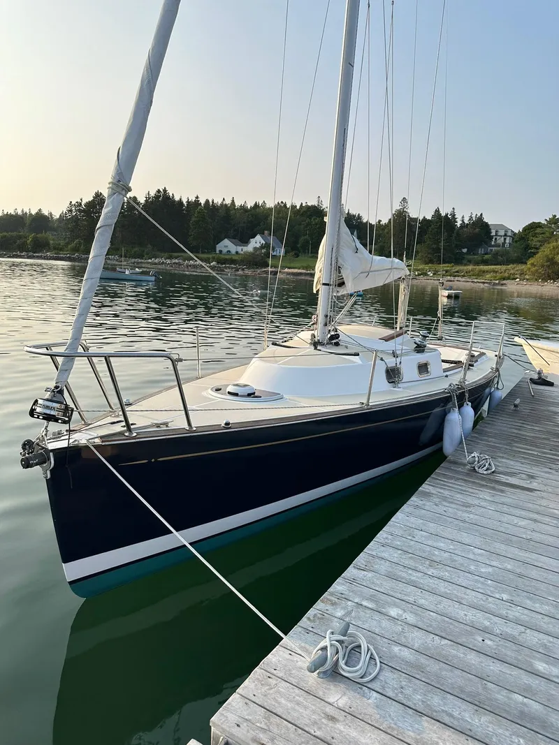 Slide: The Image of 2014 Tartan Fantail sailboat docked on calm water with scenic forest backdrop. - 30