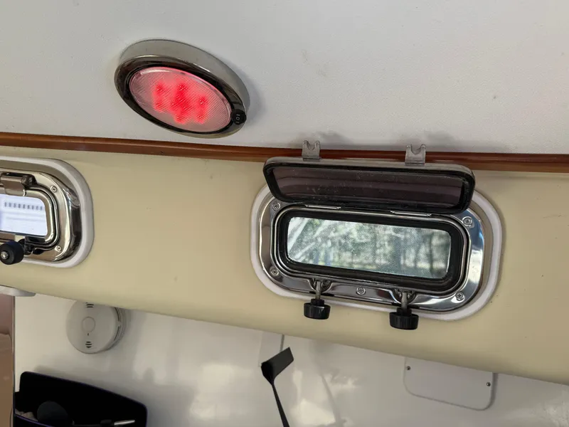 Slide: The Image of 2014 Tartan Fantail interior with porthole and red light fixture. - 33