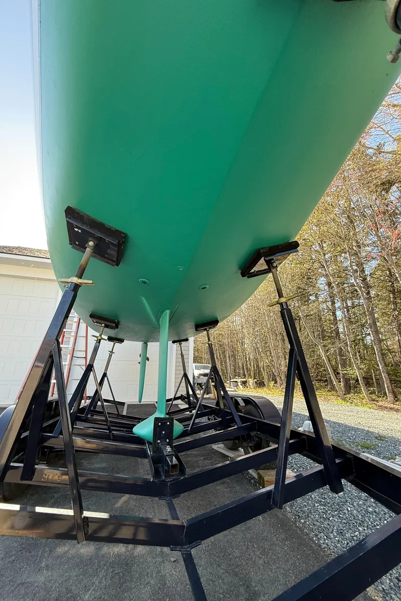 Slide: The Image of 2014 Tartan Fantail sailboat on trailer, green hull, outdoor setting. - 40
