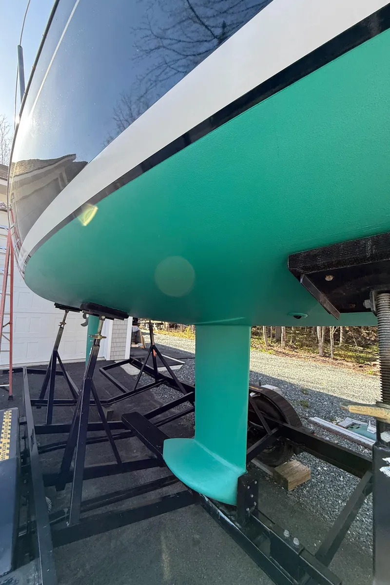 Slide: The Image of 2014 Tartan Fantail sailboat on trailer, showcasing turquoise hull and keel. - 41